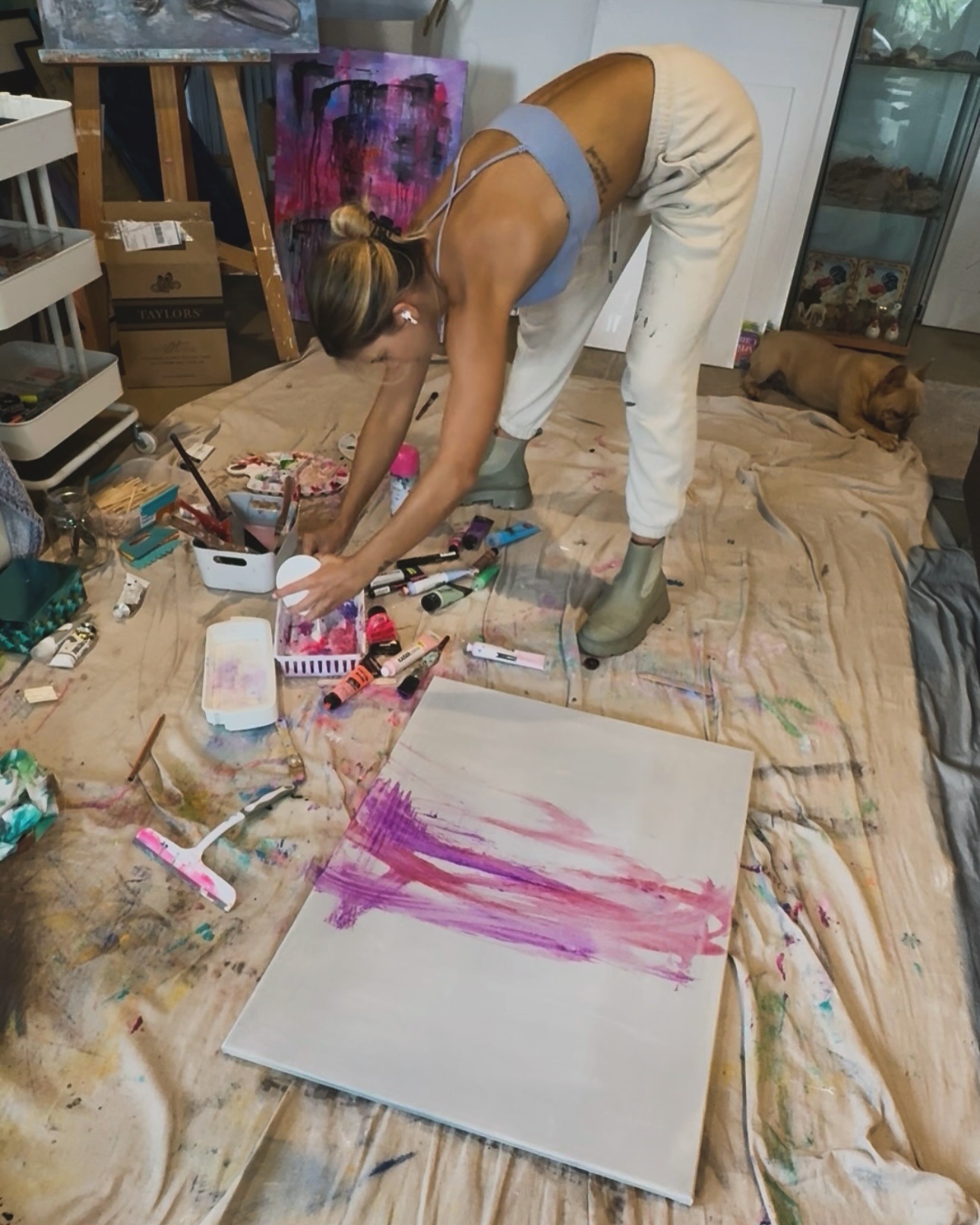 Gabrielle May in studio with colorful artwork